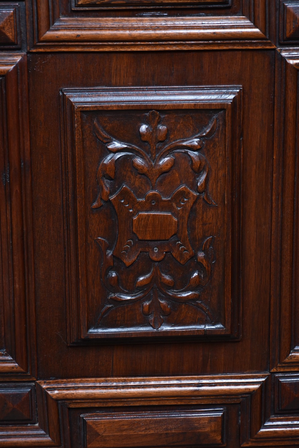 A pair of ornate dark walnut two-tier Continental cabinets featuring intricate carvings, turned columns, geometric panelled doors, and parquetry tops. View XVI