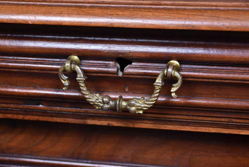 A pair of ornate dark walnut two-tier Continental cabinets featuring intricate carvings, turned columns, geometric panelled doors, and parquetry tops. View XVIII