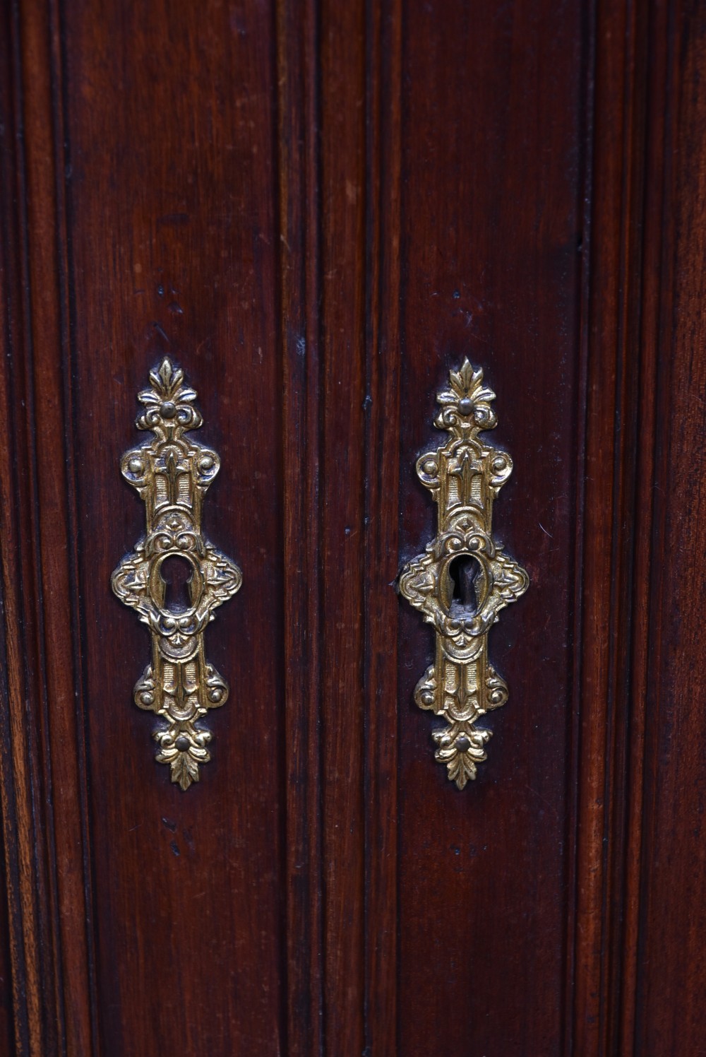 A pair of ornate dark walnut two-tier Continental cabinets featuring intricate carvings, turned columns, geometric panelled doors, and parquetry tops. View XIX