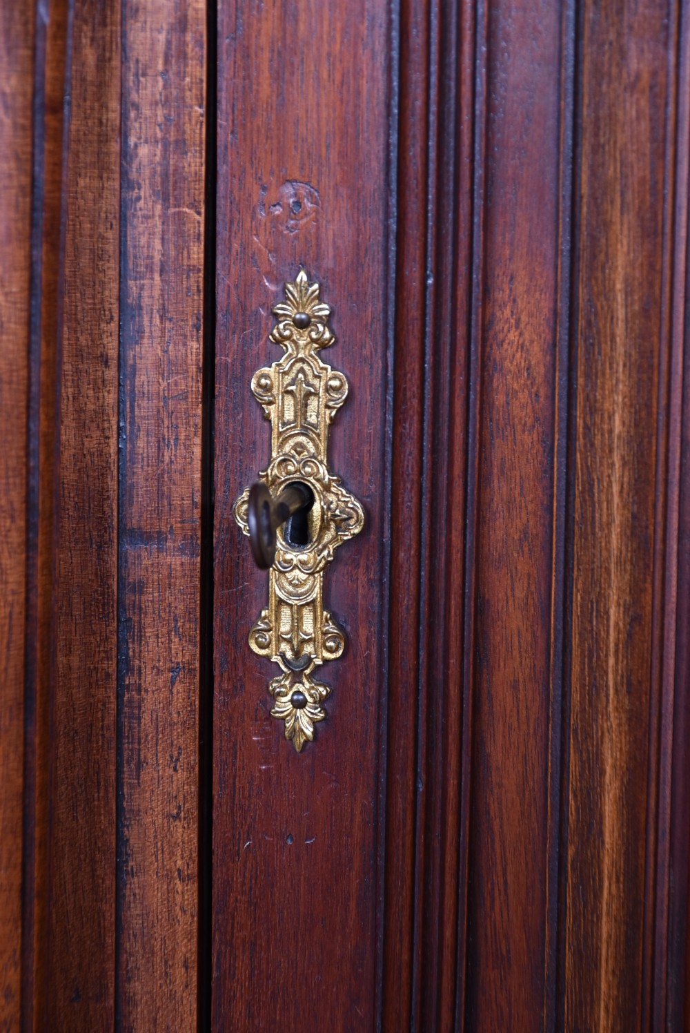 A pair of ornate dark walnut two-tier Continental cabinets featuring intricate carvings, turned columns, geometric panelled doors, and parquetry tops. View XX