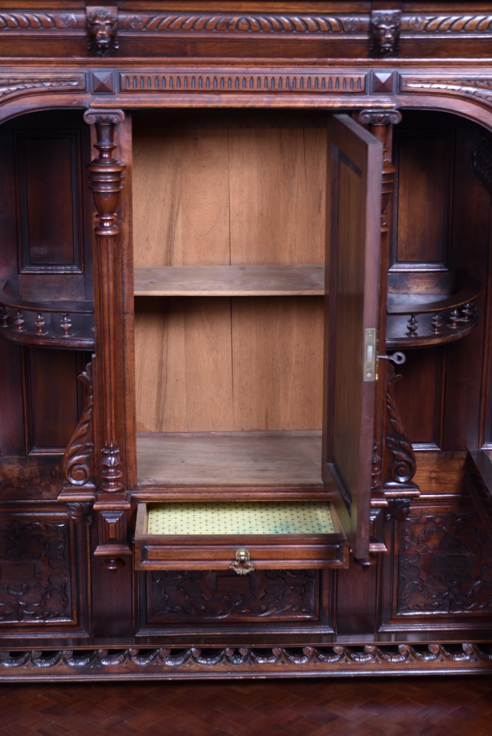 A pair of ornate dark walnut two-tier Continental cabinets featuring intricate carvings, turned columns, geometric panelled doors, and parquetry tops. View XXII