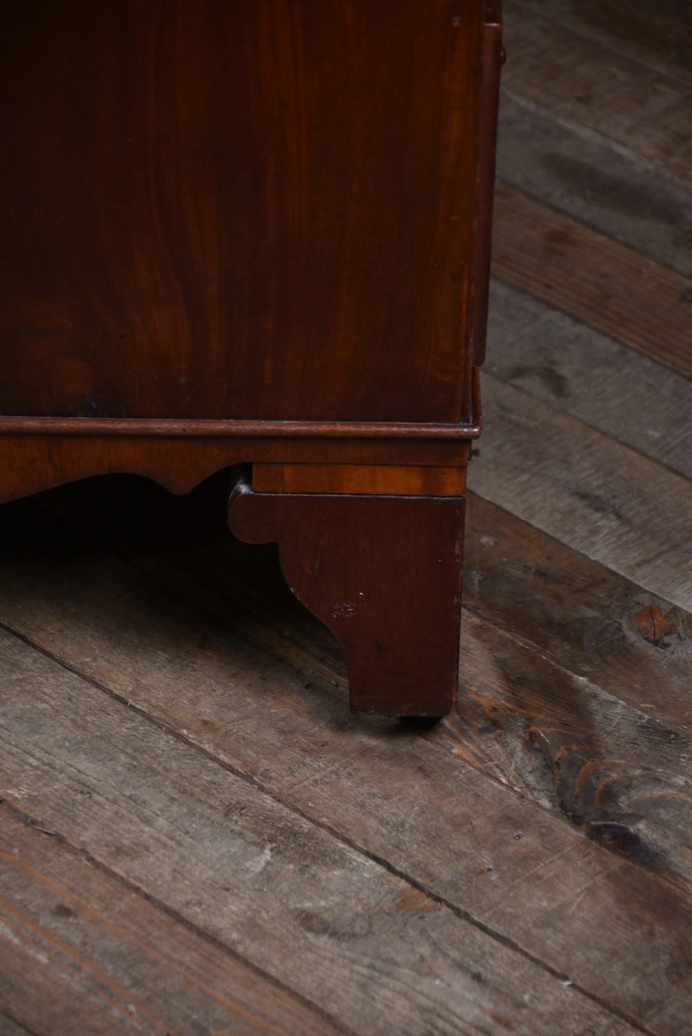 An antique Georgian mahogany slant-front writing bureau featuring four graduated drawers with brass handles and central oval marquetry inlay on the fall flap. View XXIII