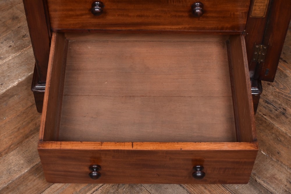 A tall Victorian mahogany Wellington chest with nine drawers, turned handles, and a side locking bar. View XII