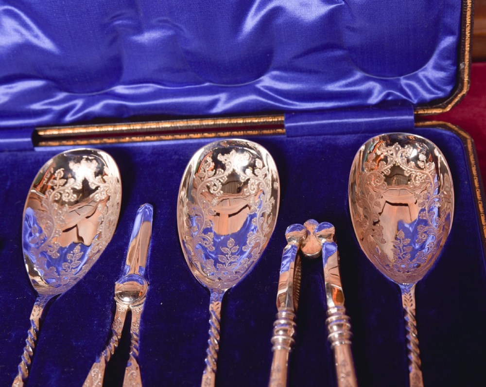 An antique cased silver-plate fruit and nut serving set with four engraved spoons, two nutcrackers, and grape shears set in a cobalt blue velvet lining. View VII