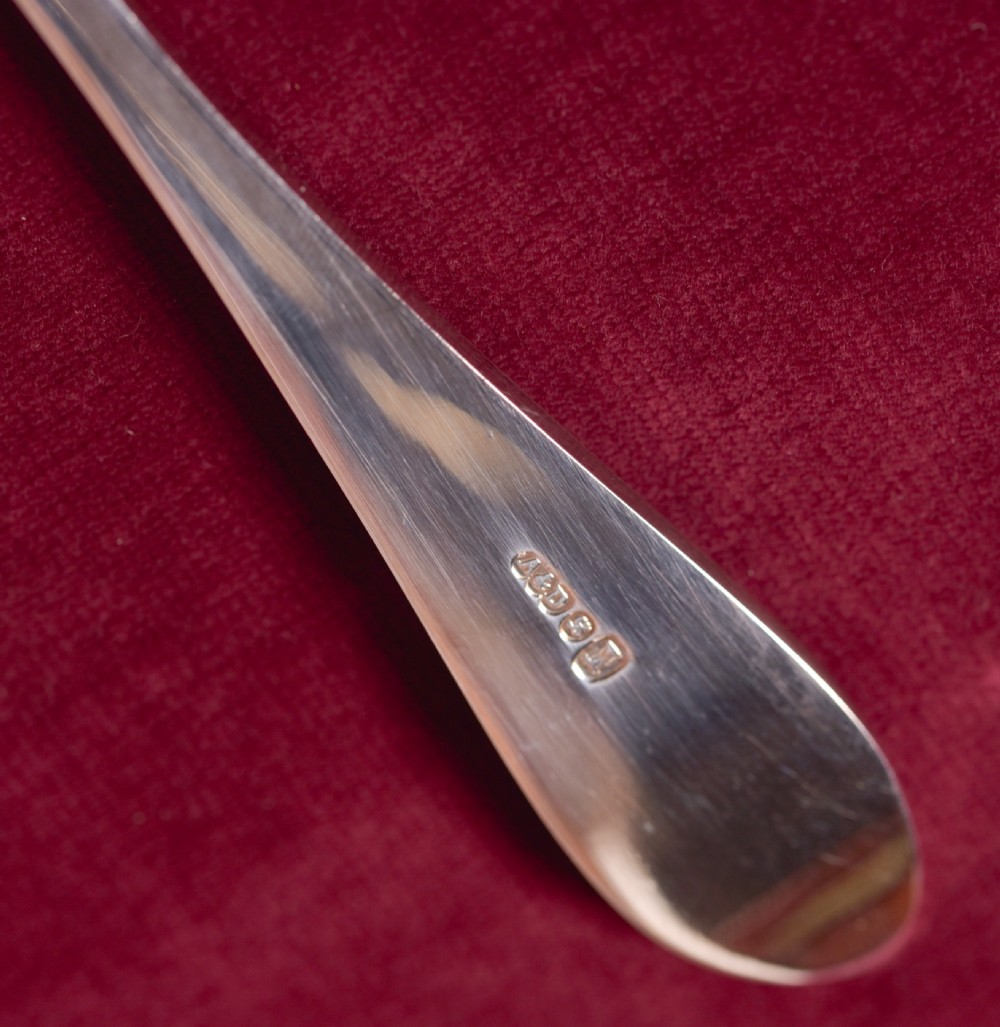 An antique cased silver-plate fruit and nut serving set with four engraved spoons, two nutcrackers, and grape shears set in a cobalt blue velvet lining. View VIII