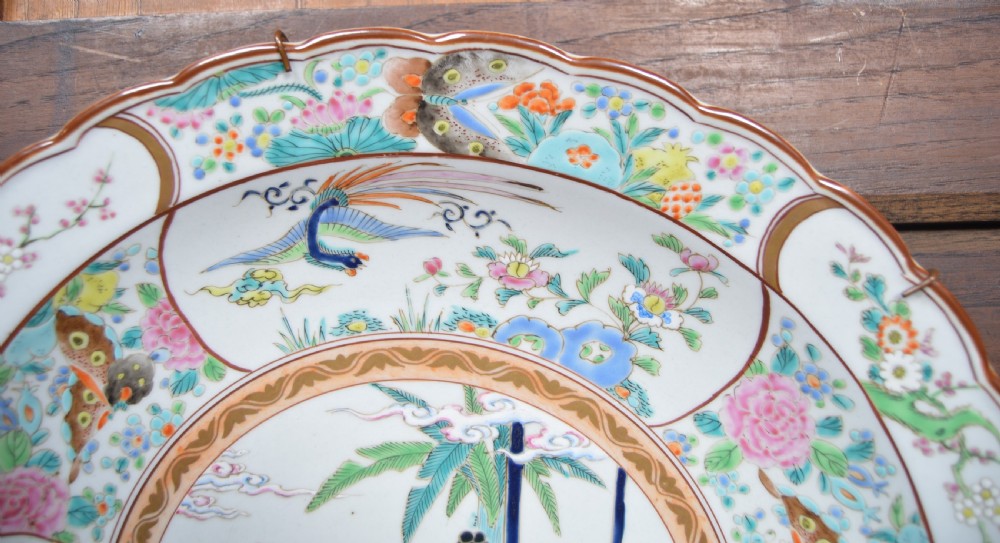 A circular hand-painted Chinese porcelain charger featuring a central figural scene surrounded by floral panels with birds and butterflies. View V