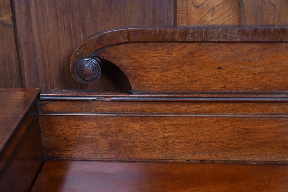 A Regency flame mahogany pedestal sideboard featuring side cupboard pedestals with spiral rope-twist columns, a central drawer section, brass ring handles, and a low rear gallery. View XIV