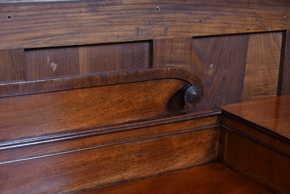 A Regency flame mahogany pedestal sideboard featuring side cupboard pedestals with spiral rope-twist columns, a central drawer section, brass ring handles, and a low rear gallery. View XV