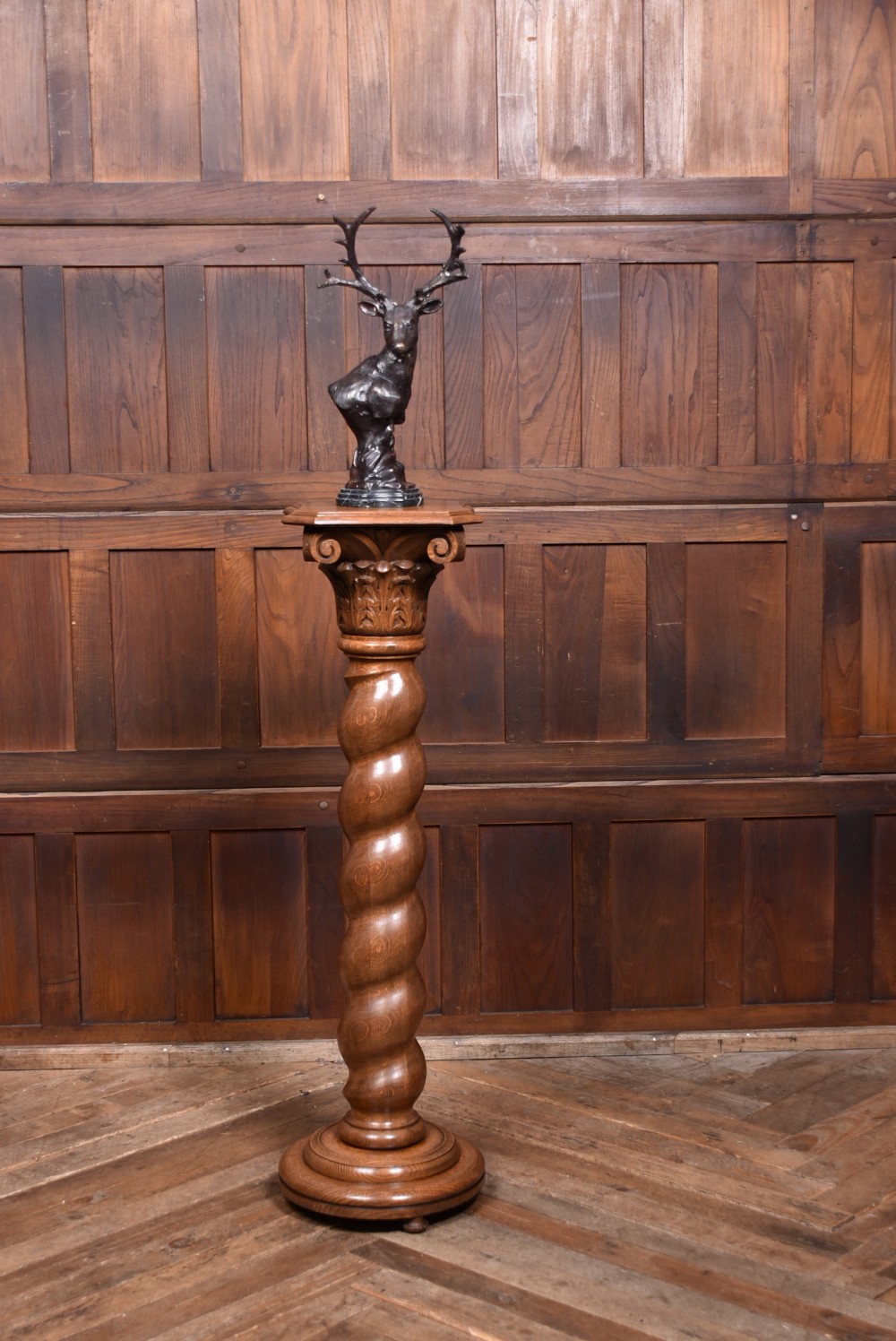 A tall Victorian carved oak pedestal featuring a Corinthian-style capital, a central spiral twist column, and a circular moulded base. View II