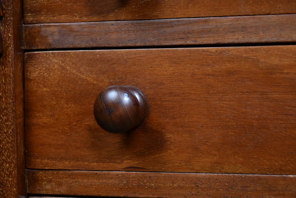 A tall Victorian mahogany Wellington chest featuring seven graduated drawers with turned knobs and a carved side locking pilaster. View VIII