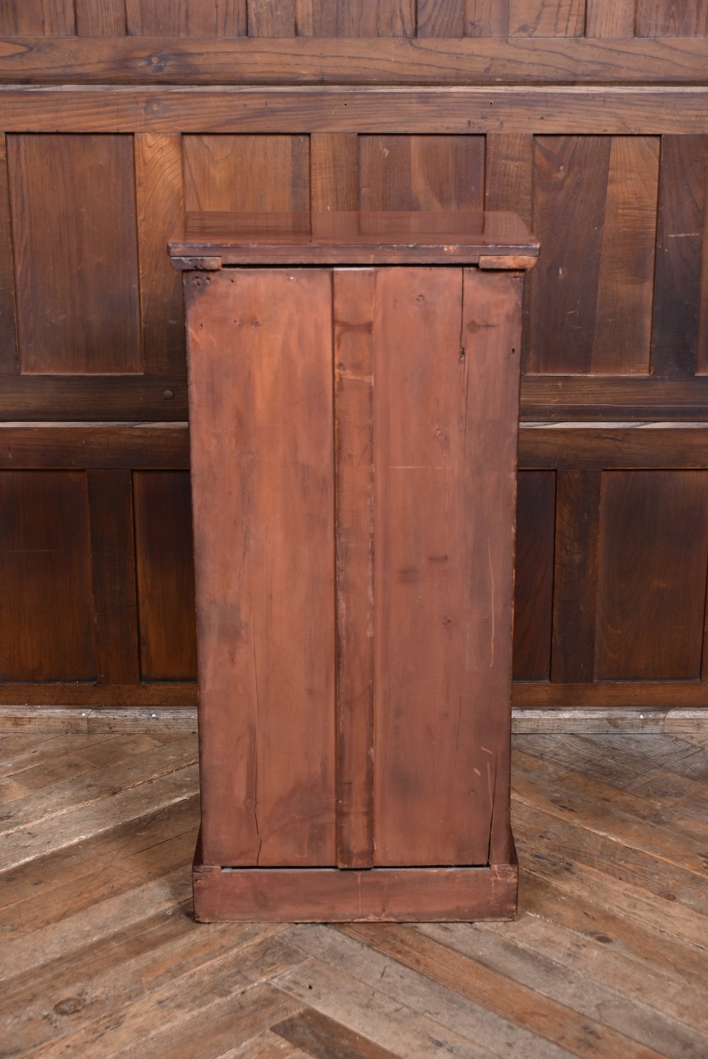 A tall Victorian mahogany Wellington chest featuring seven graduated drawers with turned knobs and a carved side locking pilaster. View XIV