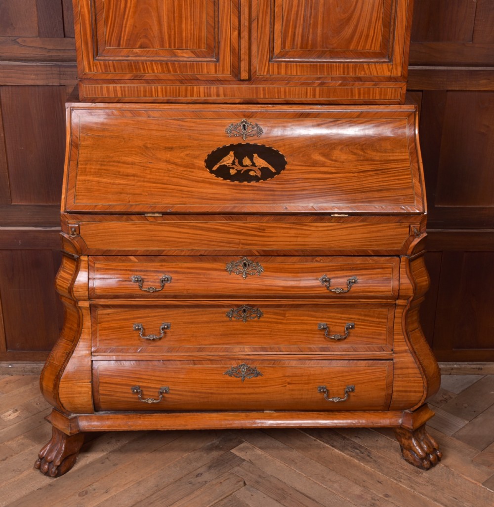 An 18th-century Dutch walnut bombe bureau bookcase featuring inlaid bird motifs, a sloping drop-front desk, shaped drawers, and carved claw feet. View III