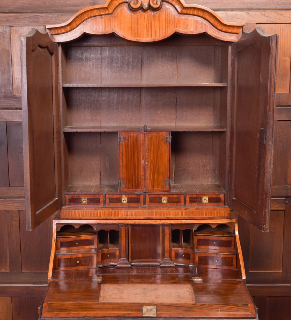 An 18th-century Dutch walnut bombe bureau bookcase featuring inlaid bird motifs, a sloping drop-front desk, shaped drawers, and carved claw feet. View VI