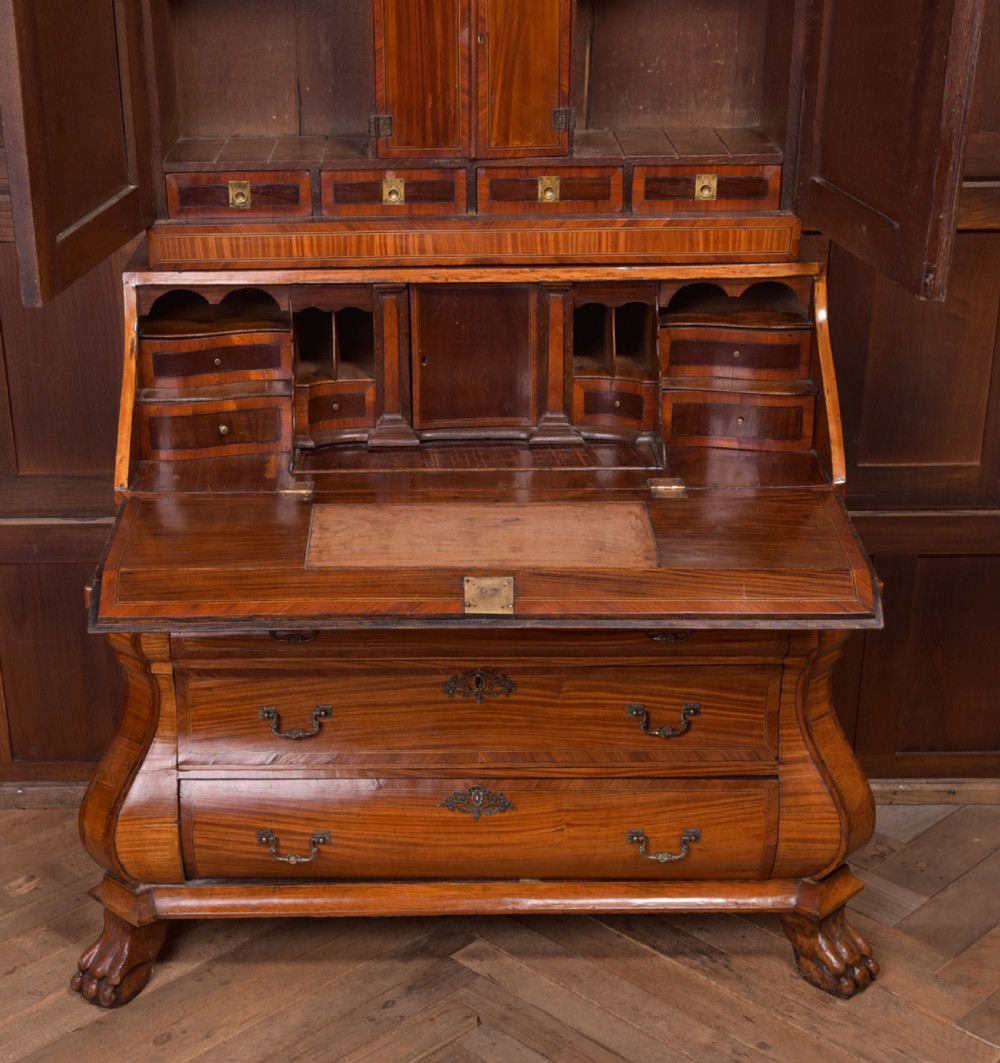 An 18th-century Dutch walnut bombe bureau bookcase featuring inlaid bird motifs, a sloping drop-front desk, shaped drawers, and carved claw feet. View VII