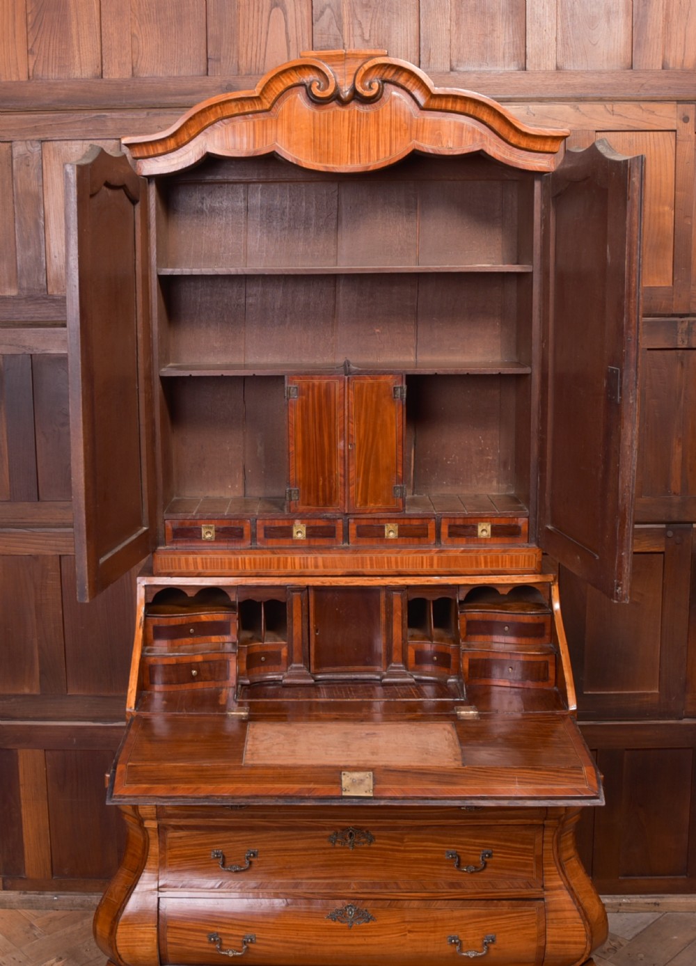 An 18th-century Dutch walnut bombe bureau bookcase featuring inlaid bird motifs, a sloping drop-front desk, shaped drawers, and carved claw feet. View VIII