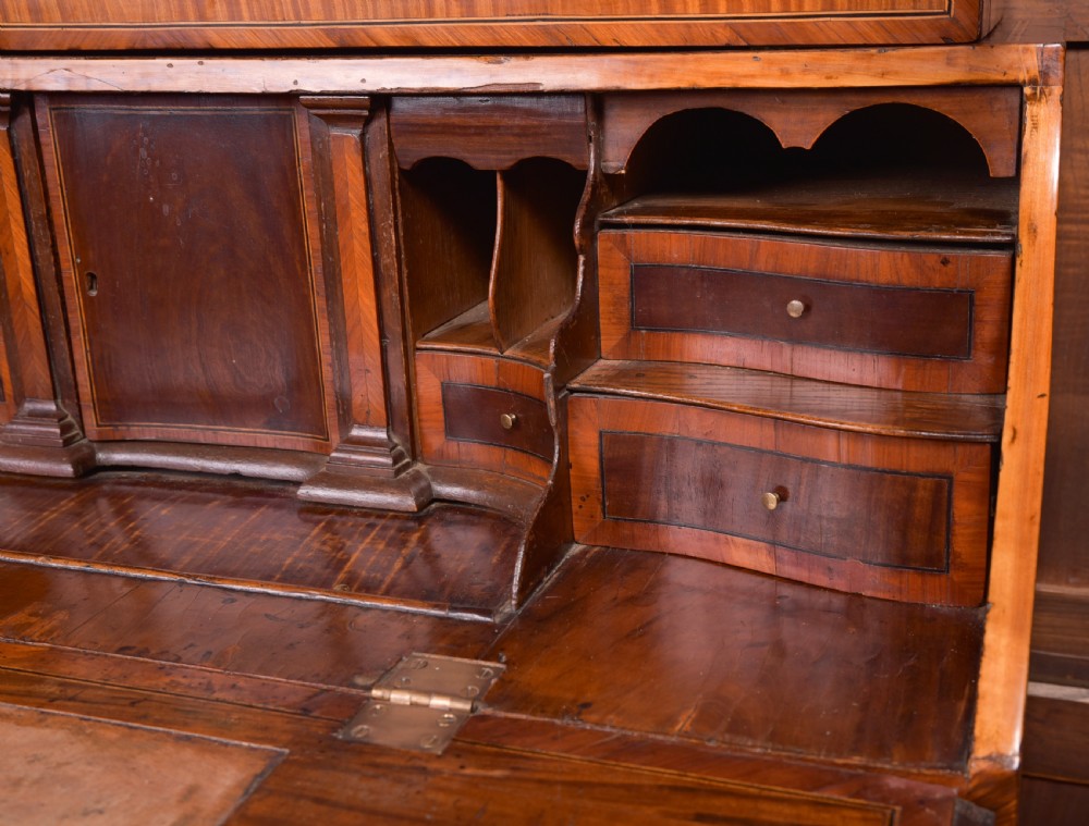 An 18th-century Dutch walnut bombe bureau bookcase featuring inlaid bird motifs, a sloping drop-front desk, shaped drawers, and carved claw feet. View IX