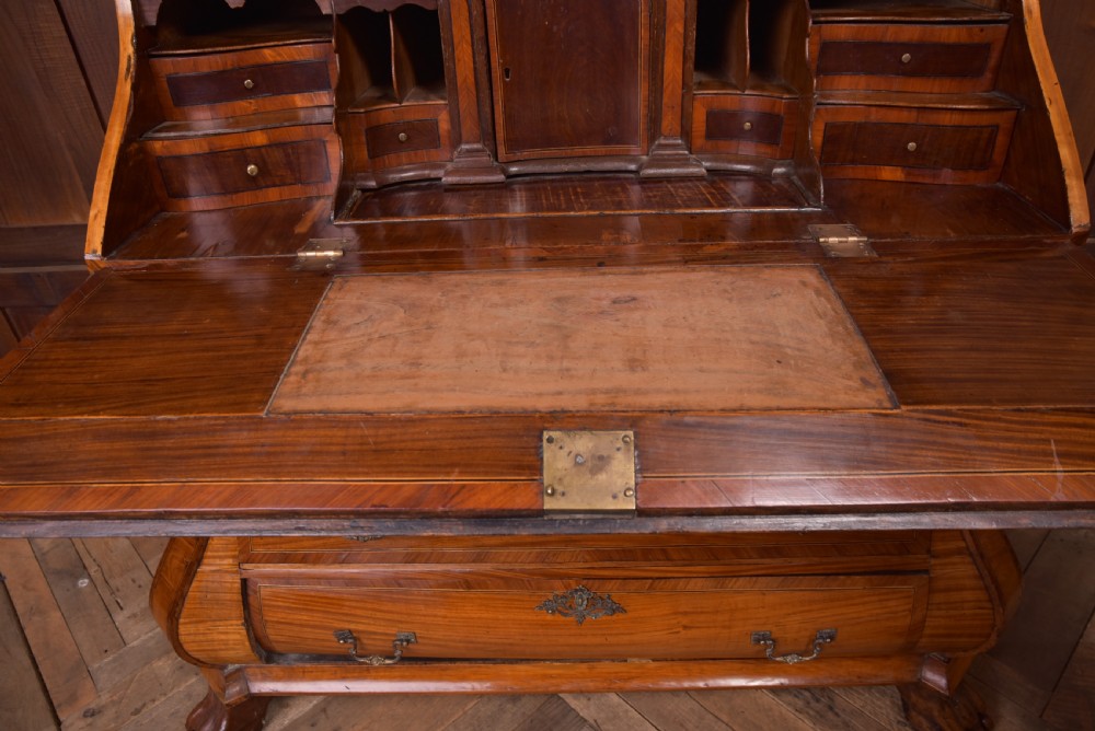An 18th-century Dutch walnut bombe bureau bookcase featuring inlaid bird motifs, a sloping drop-front desk, shaped drawers, and carved claw feet. View XII
