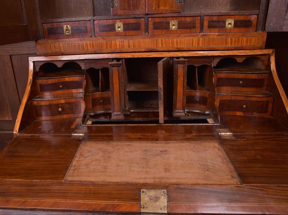 An 18th-century Dutch walnut bombe bureau bookcase featuring inlaid bird motifs, a sloping drop-front desk, shaped drawers, and carved claw feet. View XIII