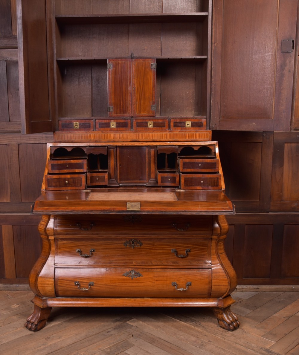 An 18th-century Dutch walnut bombe bureau bookcase featuring inlaid bird motifs, a sloping drop-front desk, shaped drawers, and carved claw feet. View XIV