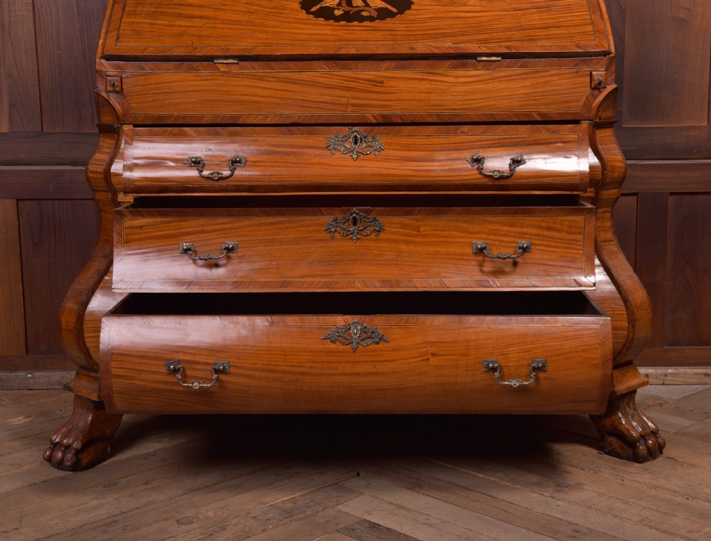 An 18th-century Dutch walnut bombe bureau bookcase featuring inlaid bird motifs, a sloping drop-front desk, shaped drawers, and carved claw feet. View XV