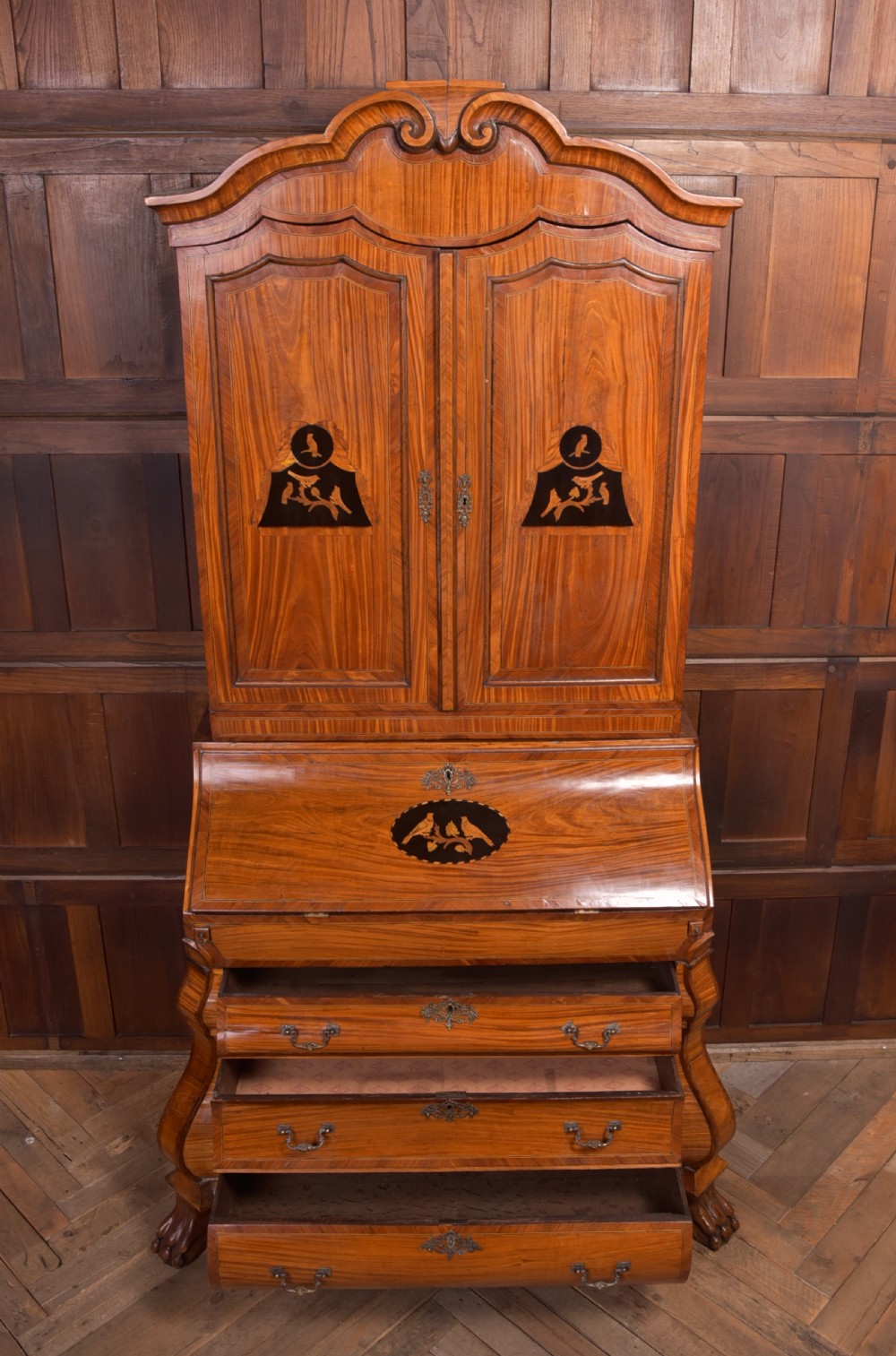 An 18th-century Dutch walnut bombe bureau bookcase featuring inlaid bird motifs, a sloping drop-front desk, shaped drawers, and carved claw feet. View XVI