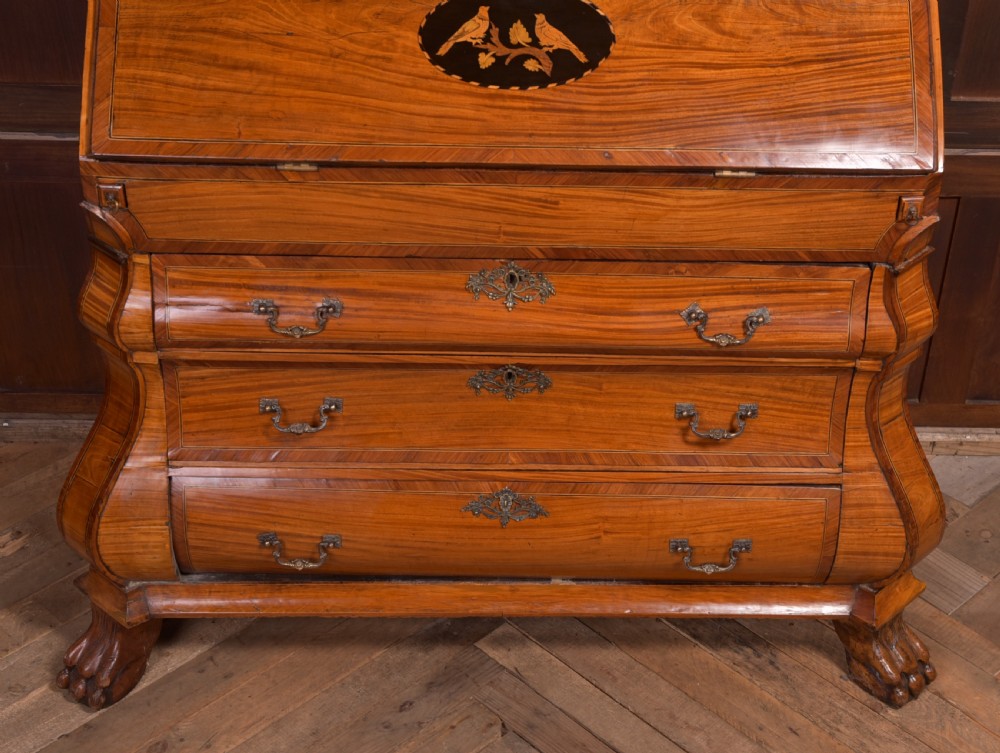An 18th-century Dutch walnut bombe bureau bookcase featuring inlaid bird motifs, a sloping drop-front desk, shaped drawers, and carved claw feet. View XIX