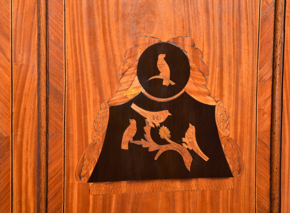 An 18th-century Dutch walnut bombe bureau bookcase featuring inlaid bird motifs, a sloping drop-front desk, shaped drawers, and carved claw feet. View XXV