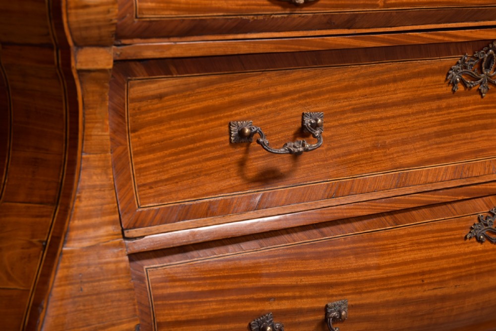 An 18th-century Dutch walnut bombe bureau bookcase featuring inlaid bird motifs, a sloping drop-front desk, shaped drawers, and carved claw feet. View XXVIII