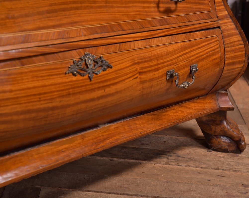 An 18th-century Dutch walnut bombe bureau bookcase featuring inlaid bird motifs, a sloping drop-front desk, shaped drawers, and carved claw feet. View XXX