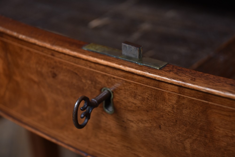 An Edwardian mahogany sideboard featuring satinwood string inlay, a curved central drawer, flanking cupboard doors, a raised superstructure, and square tapered legs. View XV