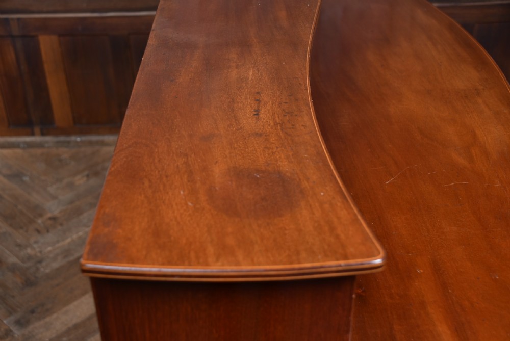 An Edwardian mahogany sideboard featuring satinwood string inlay, a curved central drawer, flanking cupboard doors, a raised superstructure, and square tapered legs. View XXIII
