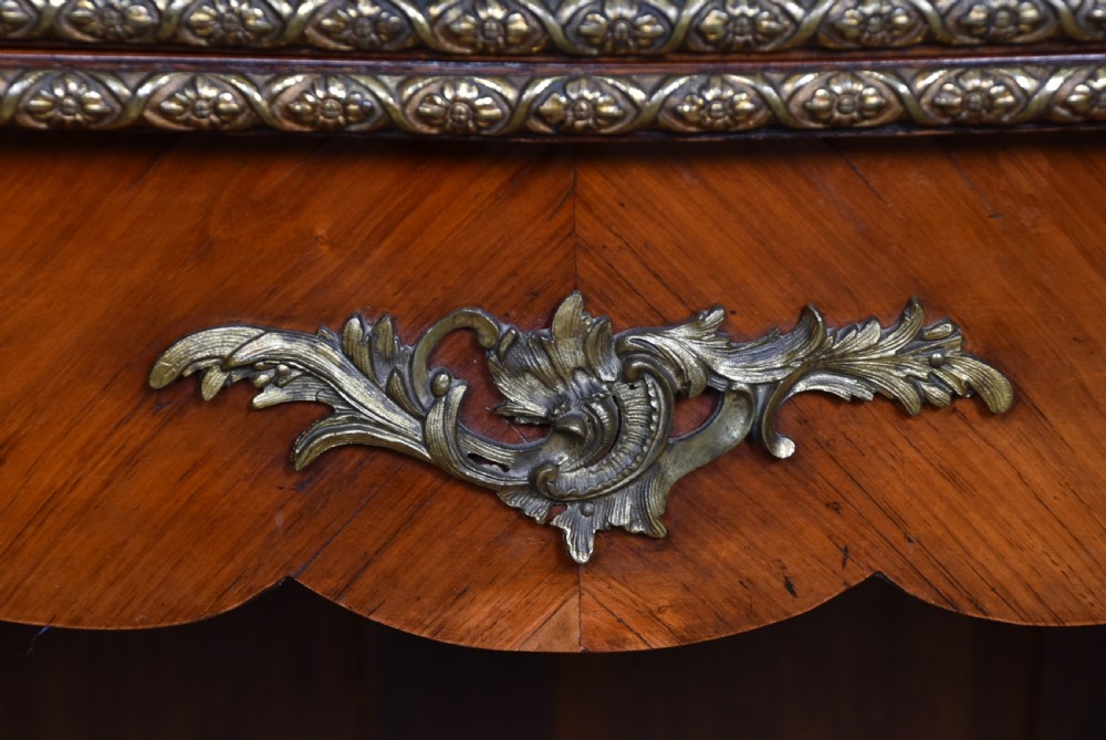 A Victorian Louis XV style marquetry card table featuring cabriole legs, brass mounts, a serpentine apron, and a fold-over top. View V