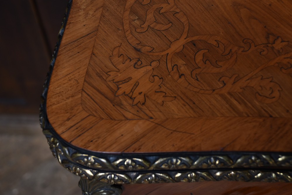 A Victorian Louis XV style marquetry card table featuring cabriole legs, brass mounts, a serpentine apron, and a fold-over top. View XI