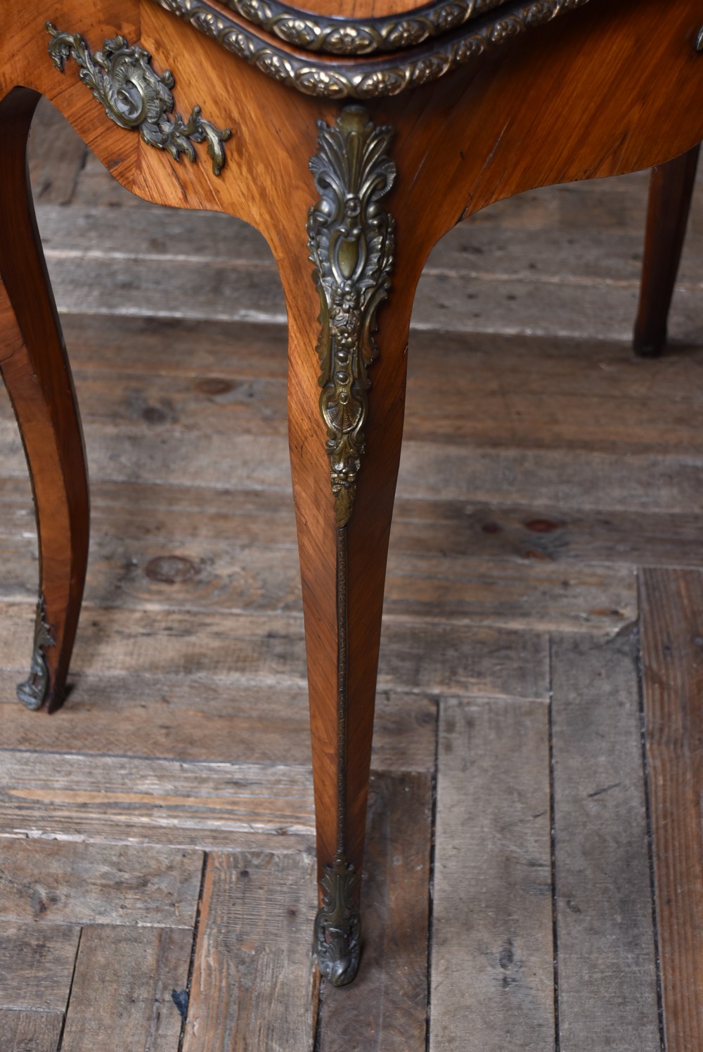 A Victorian Louis XV style marquetry card table featuring cabriole legs, brass mounts, a serpentine apron, and a fold-over top. View XII