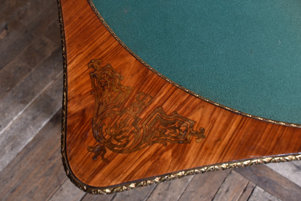 A Victorian Louis XV style marquetry card table featuring cabriole legs, brass mounts, a serpentine apron, and a fold-over top. View XIX