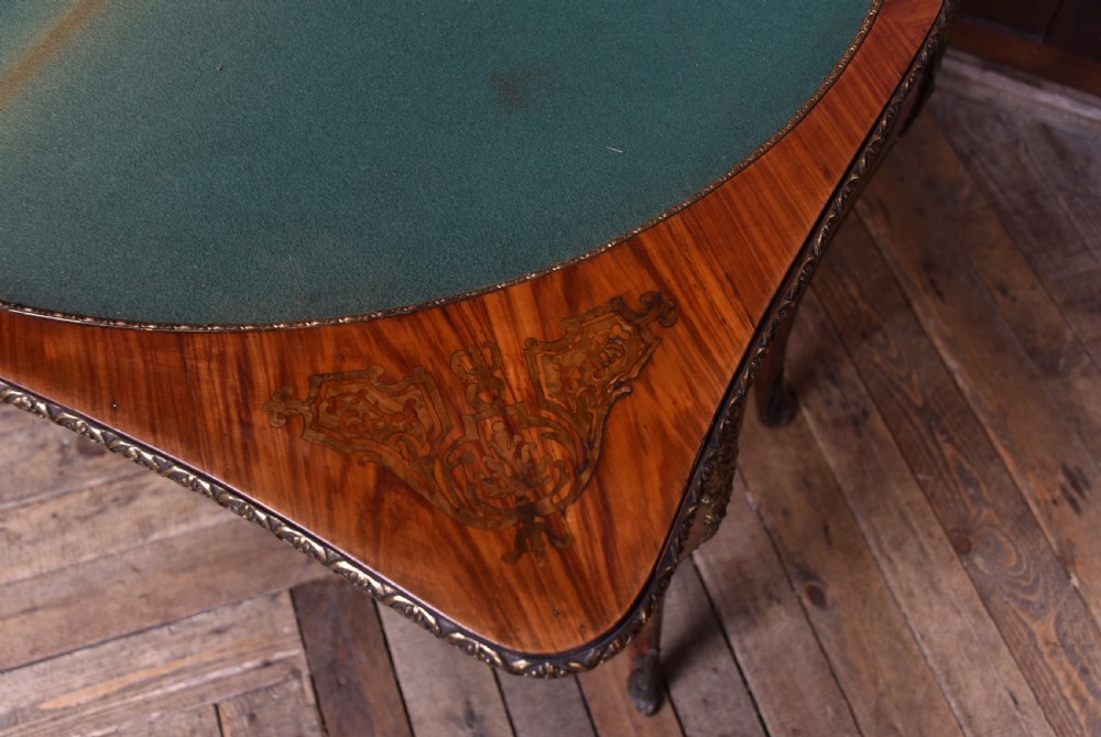 A Victorian Louis XV style marquetry card table featuring cabriole legs, brass mounts, a serpentine apron, and a fold-over top. View XX