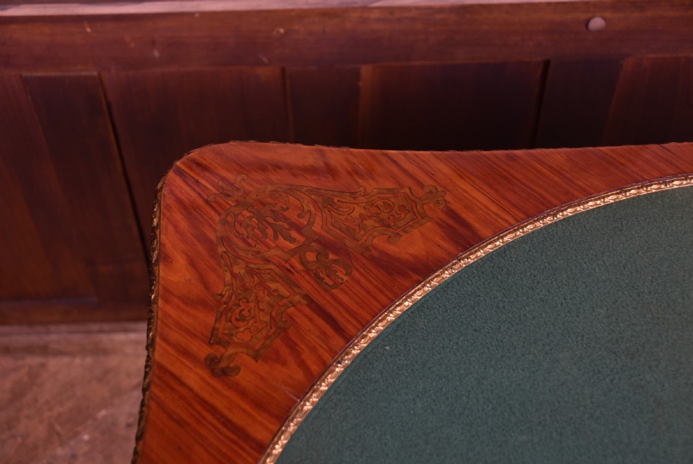 A Victorian Louis XV style marquetry card table featuring cabriole legs, brass mounts, a serpentine apron, and a fold-over top. View XXII