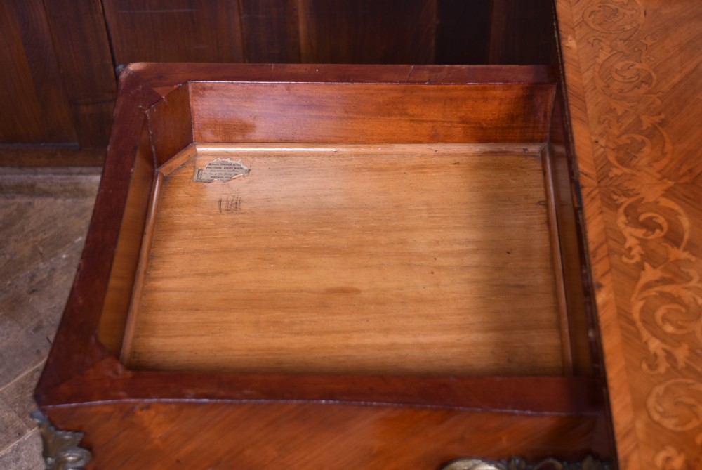 A Victorian Louis XV style marquetry card table featuring cabriole legs, brass mounts, a serpentine apron, and a fold-over top. View XXIII