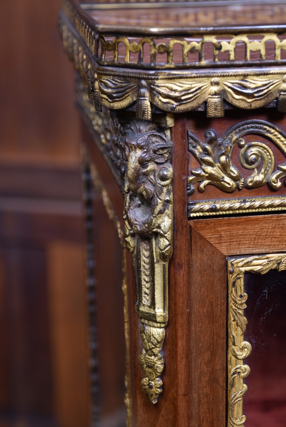 A French Louis XV style timber vitrine featuring a red marble top, gilded mounts, a glass front door, and a red velvet interior. View V