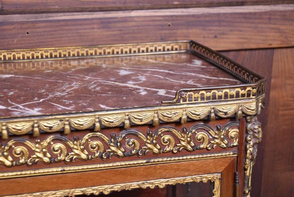 A French Louis XV style timber vitrine featuring a red marble top, gilded mounts, a glass front door, and a red velvet interior. View VIII