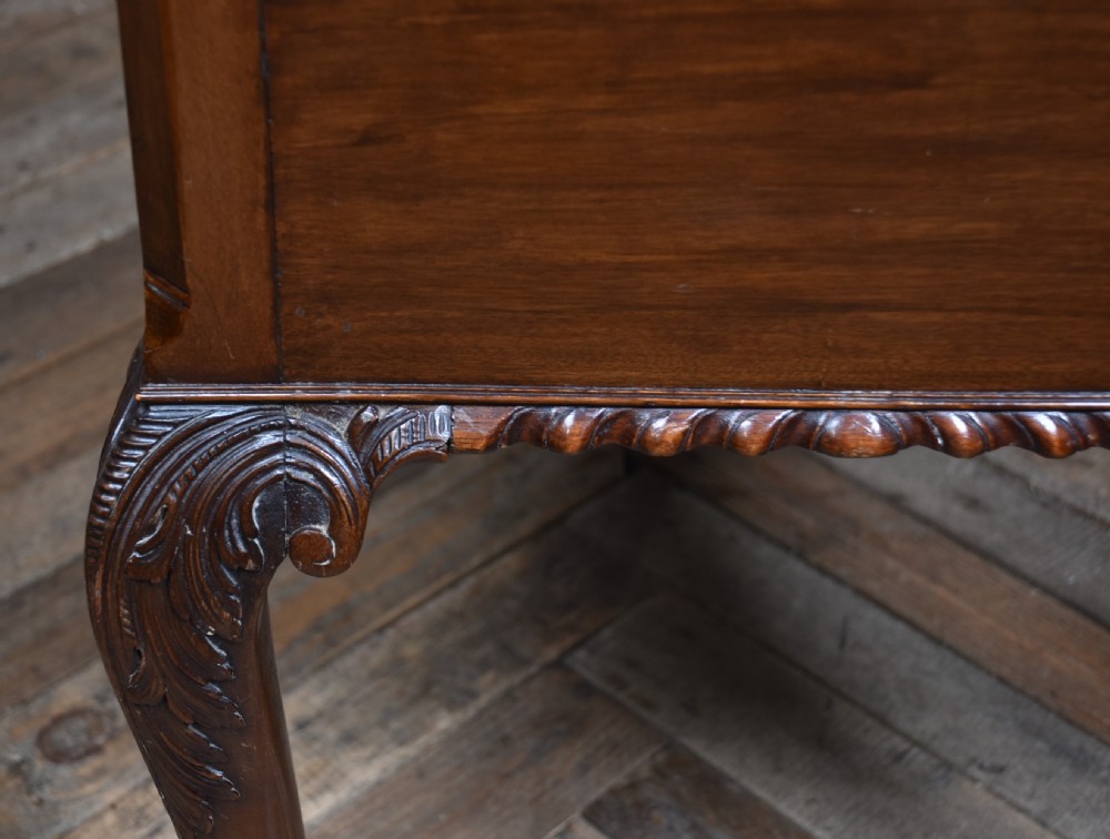 An Edwardian mahogany writing desk featuring a leather inset top, carved cabriole legs with ball-and-claw feet, and five drawers with brass swan-neck handles. View XIII
