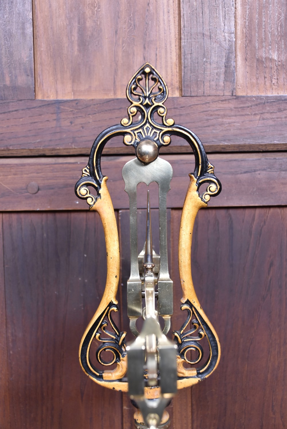 An Edwardian brass shopkeeper balance scale set on a central column base with two suspended pans and matching brass weights. View XIX