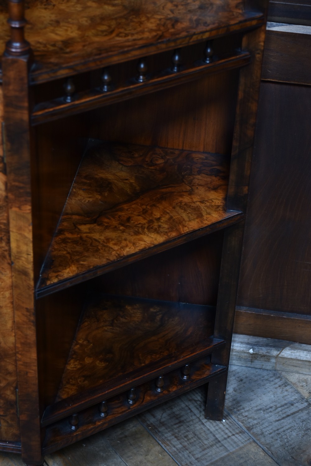 A late Victorian burr walnut display cabinet featuring tiered shelving, multiple mirror panels, turned support pillars, and carved lower cabinet doors. View VIII