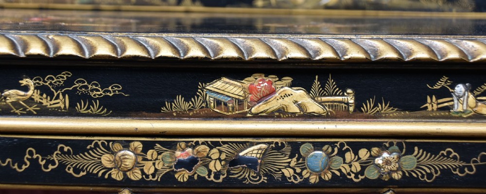An Edwardian black lacquered display cabinet featuring hand-painted gold Chinoiserie motifs, arched astragal glazing, and cabriole legs. View V