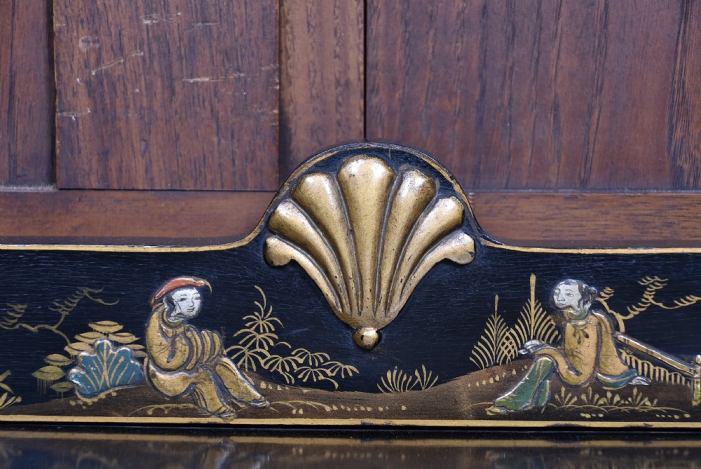 An Edwardian black lacquered display cabinet featuring hand-painted gold Chinoiserie motifs, arched astragal glazing, and cabriole legs. View XI