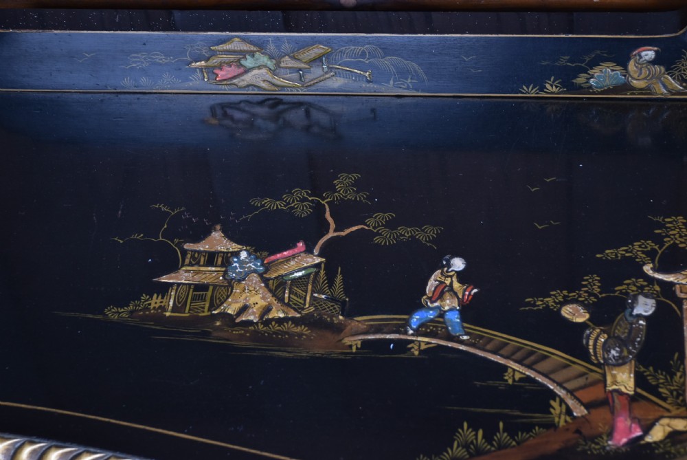 An Edwardian black lacquered display cabinet featuring hand-painted gold Chinoiserie motifs, arched astragal glazing, and cabriole legs. View XIV
