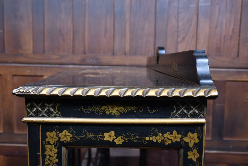An Edwardian black lacquered display cabinet featuring hand-painted gold Chinoiserie motifs, arched astragal glazing, and cabriole legs. View XXIII