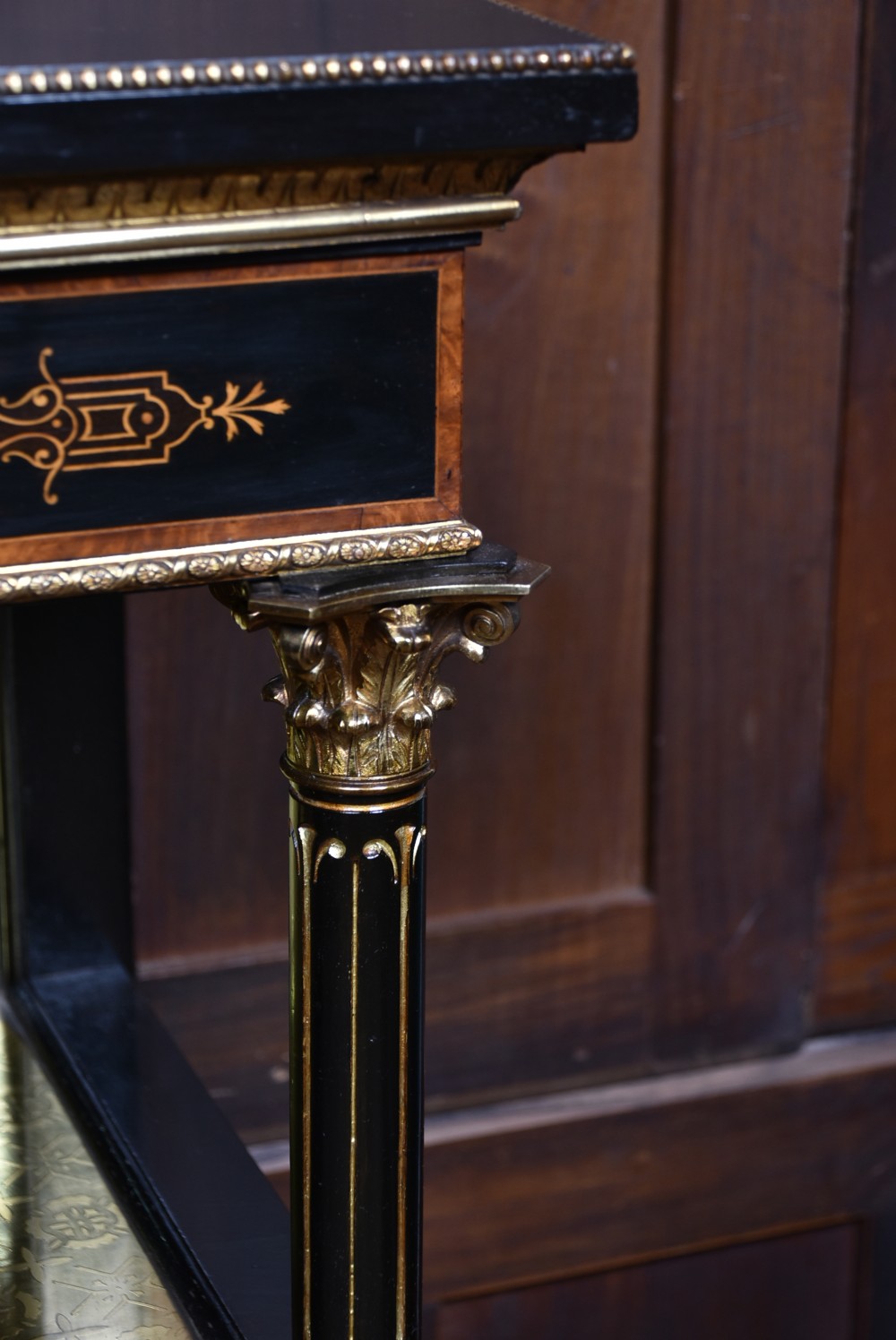 A Victorian ebonised and amboyna breakfront credenza featuring a central cupboard with a blue jasperware plaque flanked by open shelves and gilt fluted columns. View IX