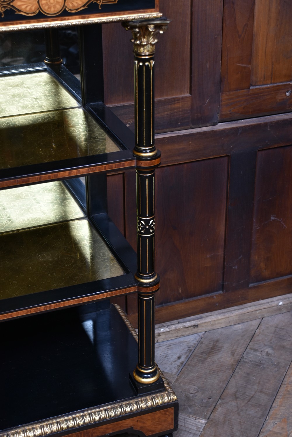A Victorian ebonised and amboyna breakfront credenza featuring a central cupboard with a blue jasperware plaque flanked by open shelves and gilt fluted columns. View XI