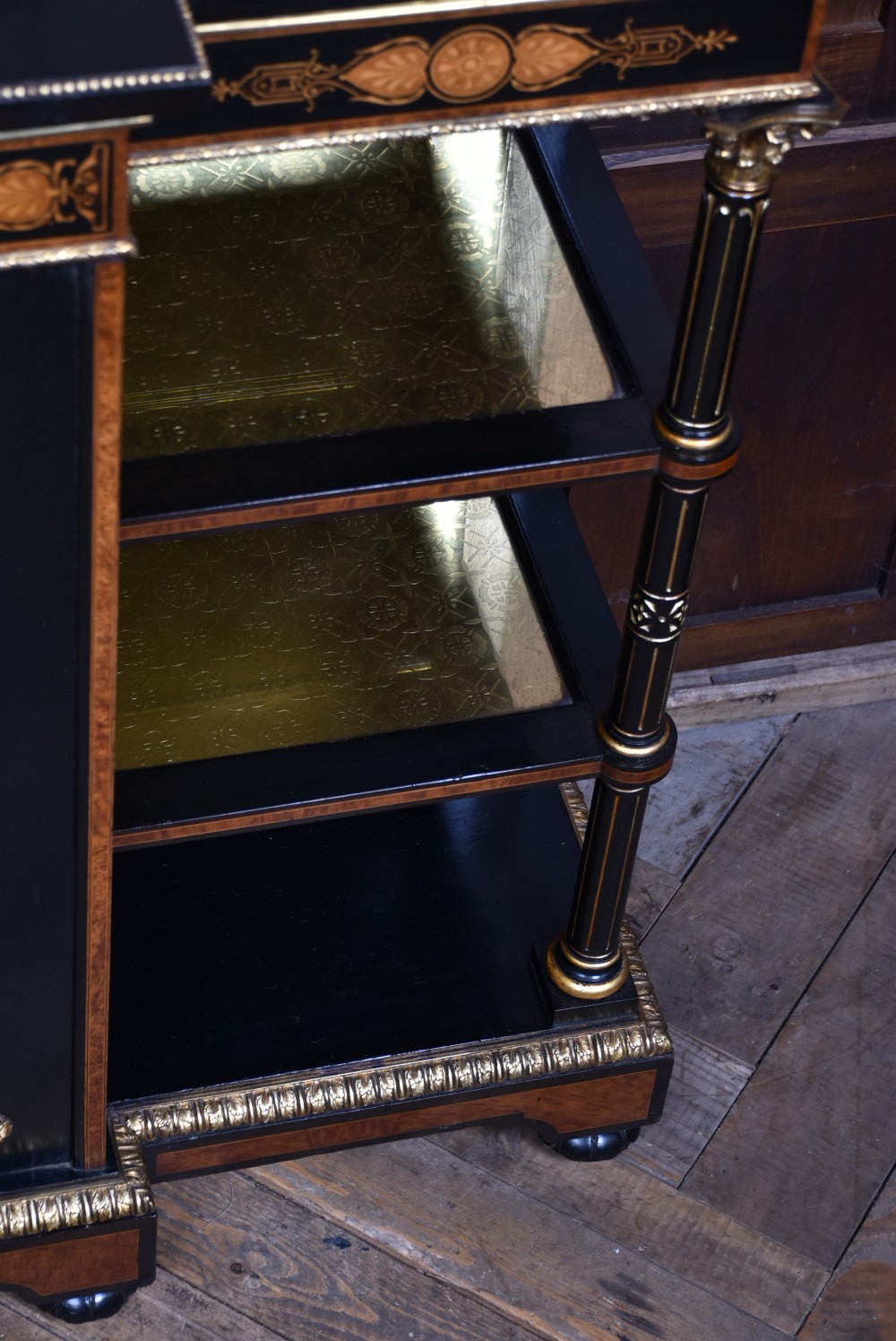 A Victorian ebonised and amboyna breakfront credenza featuring a central cupboard with a blue jasperware plaque flanked by open shelves and gilt fluted columns. View XIII